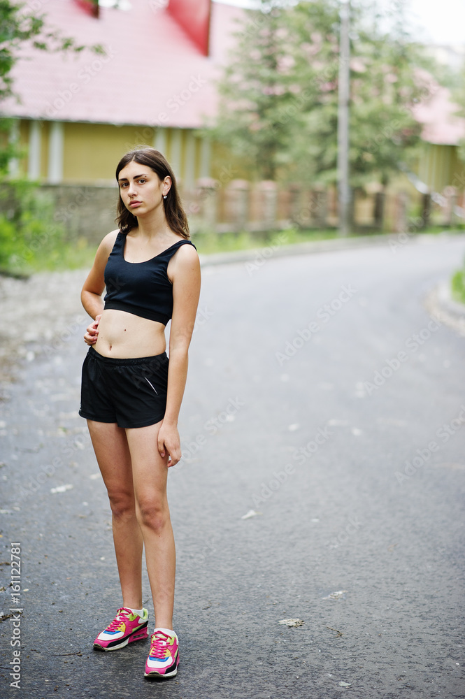 Sport girl at sportswear exercising in a green park and training at nature. A healthy lifestyle. Sport girl at sportswear exercising in a green park and training at nature. A healthy lifestyle.