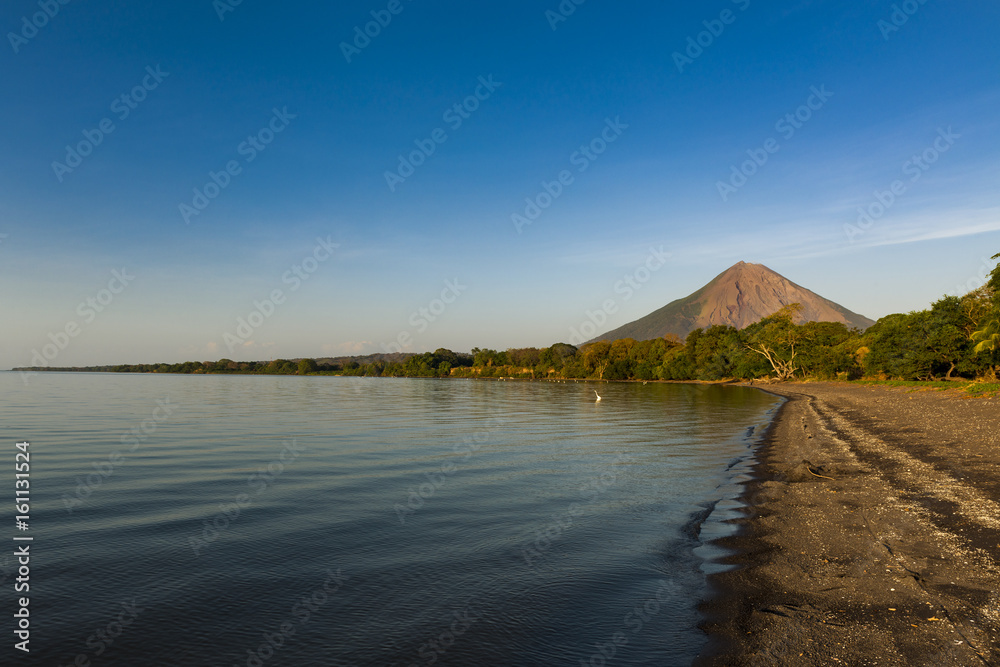 View of a beach at sunset in the Ometepe Island, with the Concepcion Volcano on the background in Nicaragua, Central America