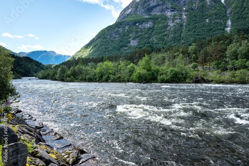 Eio, short but well watered river between the lake Eidfjordvatnet and the Eidfjorden in Norway photo