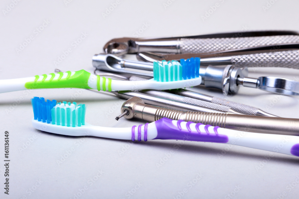 dental care toothbrush with dentist tools isolated on white background. Selective focus. dental care toothbrush with dentist tools isolated on white background. Selective focus.