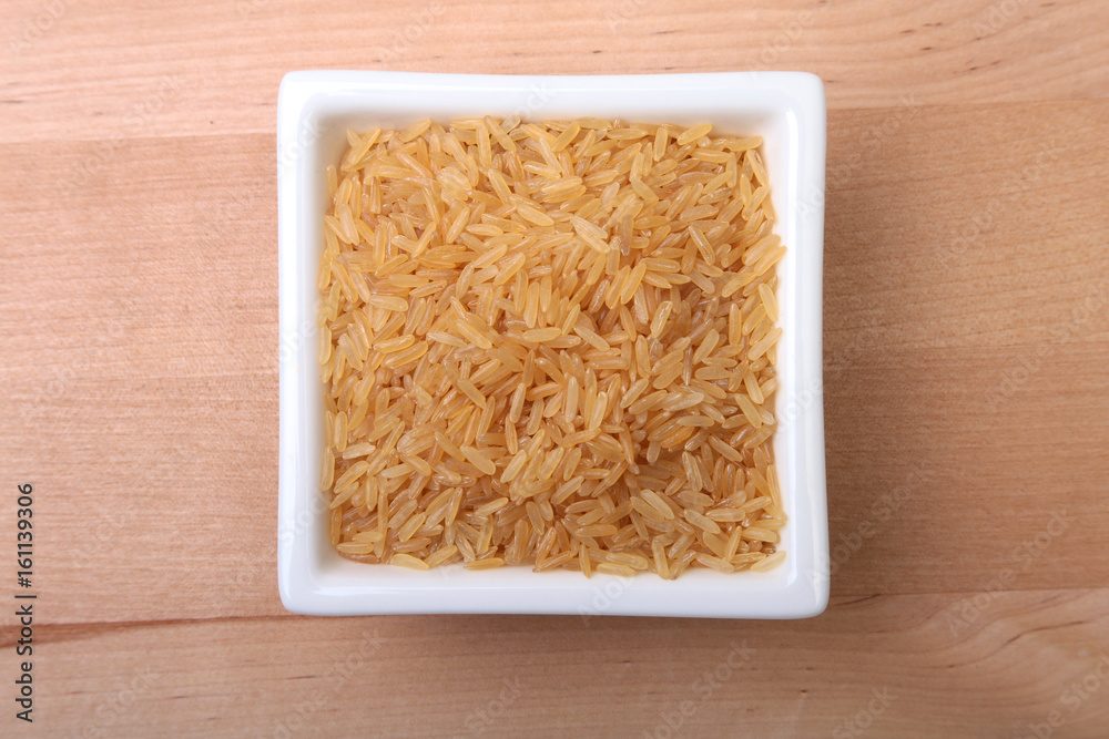 Rice in a bowl on wooden background. ready for cooking. Rice in a bowl on wooden background. ready for cooking.