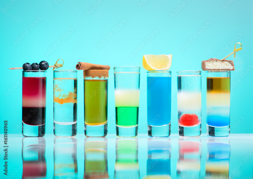 row line of different alcohol cocktails