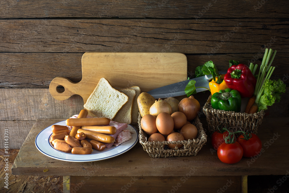 Fototapeta premium Sausage, ham and bacon in white dish and ingredient for prepare breakfast
