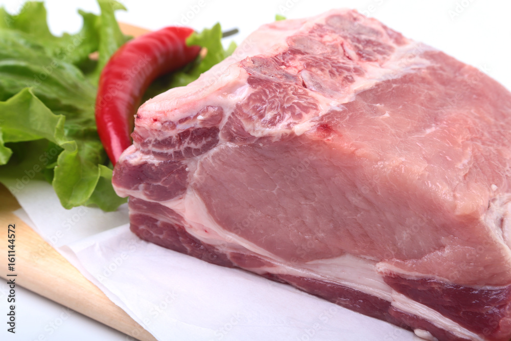 Raw pork chops with herbs and spices on cutting board. Ready for cooking.