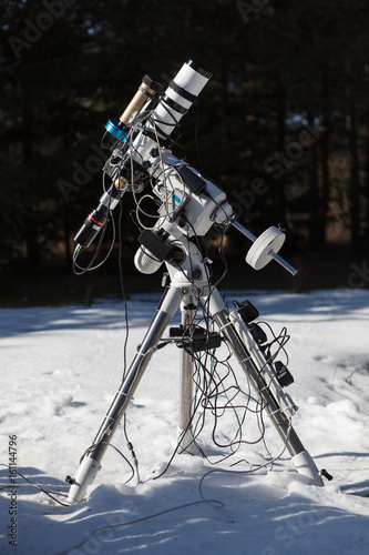 Professional astrophotography telescope equipped with guider scope and astro camera ready for night session photo