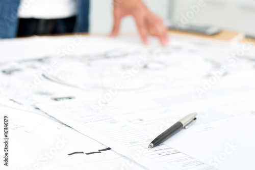 Pen and architectural blueprints on the table