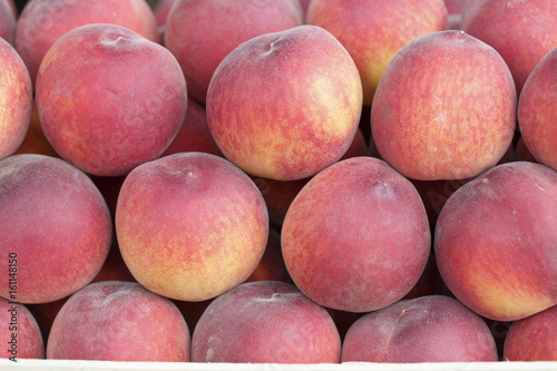 Peaches on the market  Colorful photo of peaches with defocused background  Selective focus with shallow depth of field