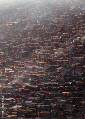 Top view monastery at Larung gar (Buddhist Academy) in a warm and foggy morning time, Sichuan, China