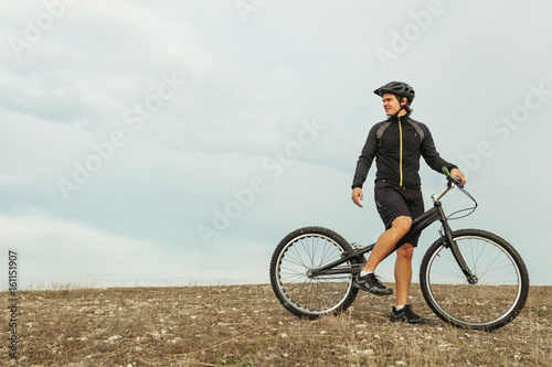 Sportsman on bike among plain