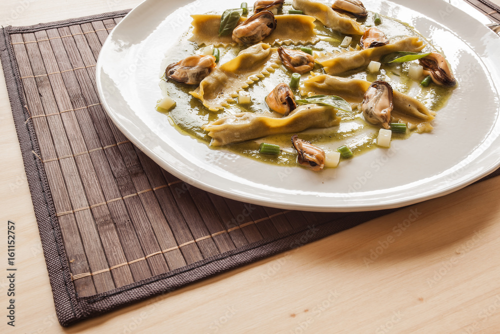 Egg pasta stuffed with mussels and vegetables in the restaurant.