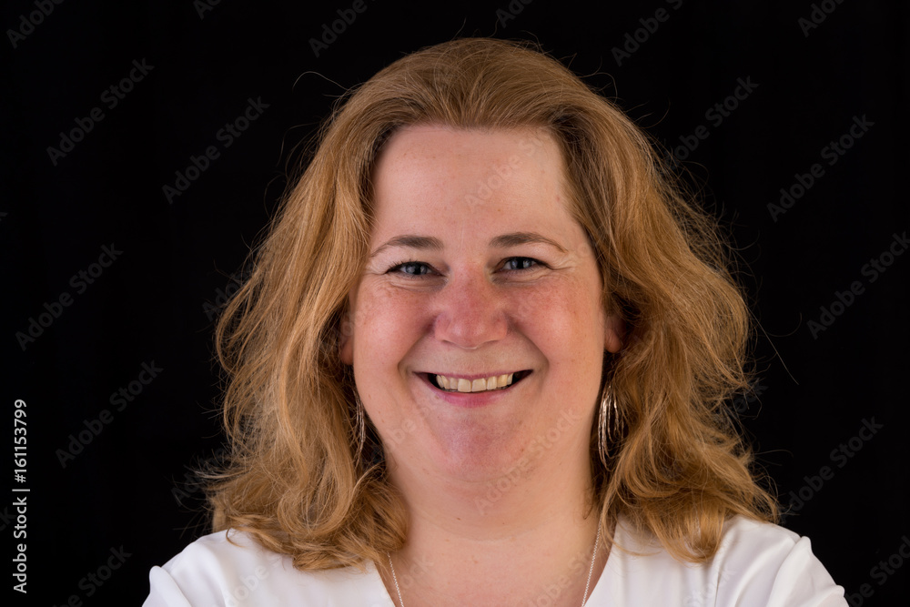 Portrait of a attractive european light overweighted red haired female in white shirt, headshot in front of black backgrouind Portrait of a attractive european light overweighted red haired female in white shirt, headshot in front of black backgrouind