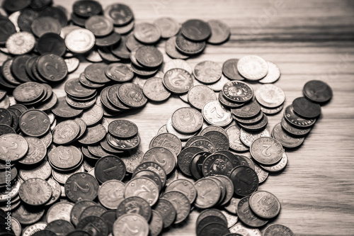 Old Latvian coins on a wooden background - monochrome vintage look