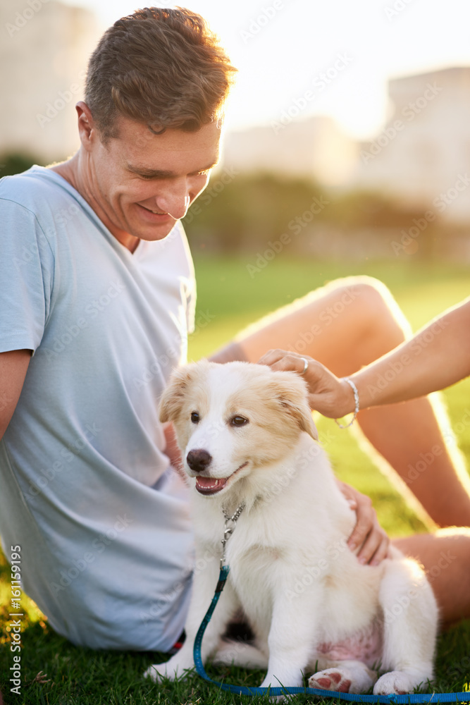 Man smiling at his puppy at sunset Man smiling at his puppy at sunset