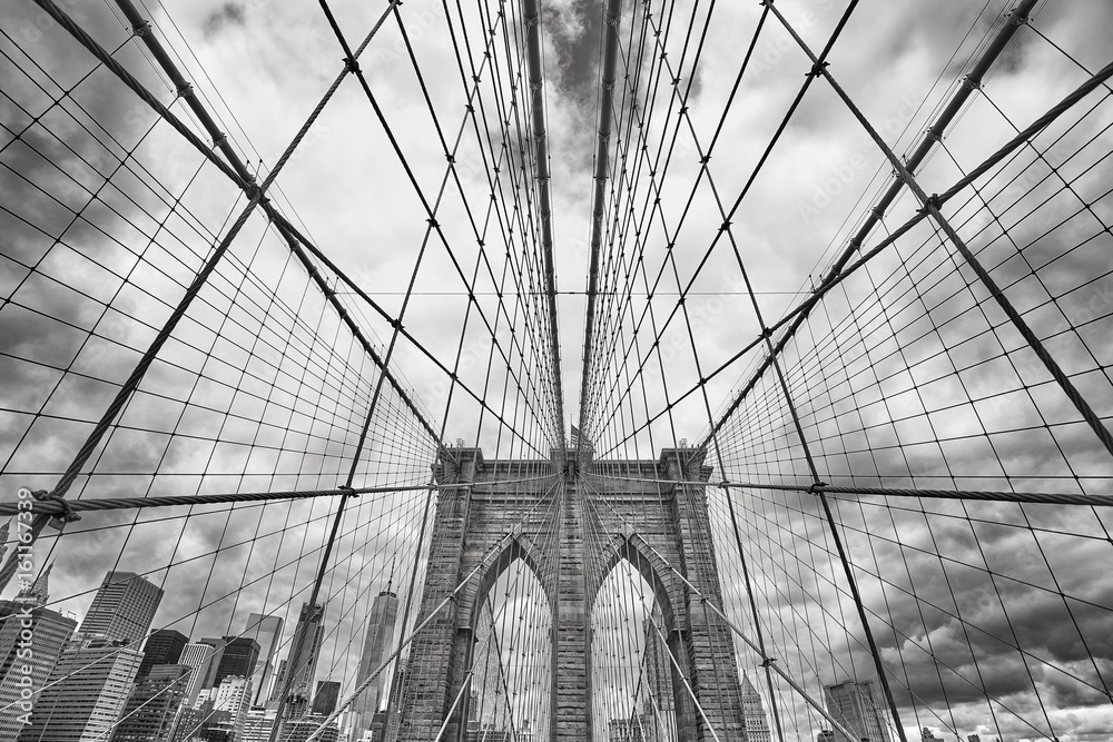 Wide angle black and white picture of Brooklyn Bridge, New York City, USA.