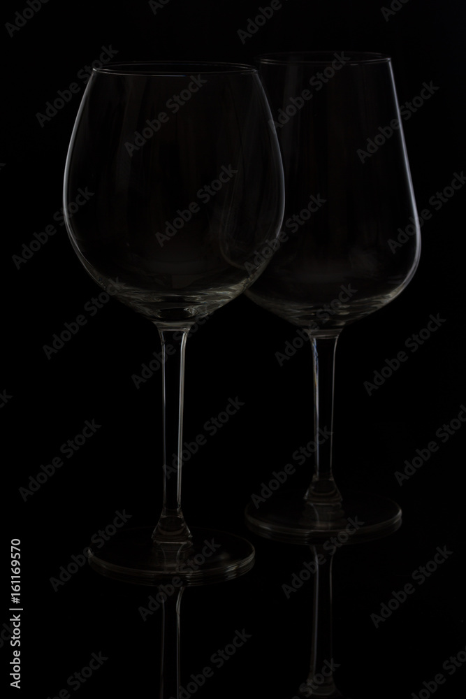 Two wine glasses on black background