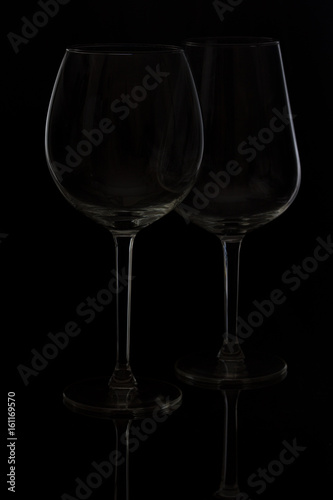 Two wine glasses on black background