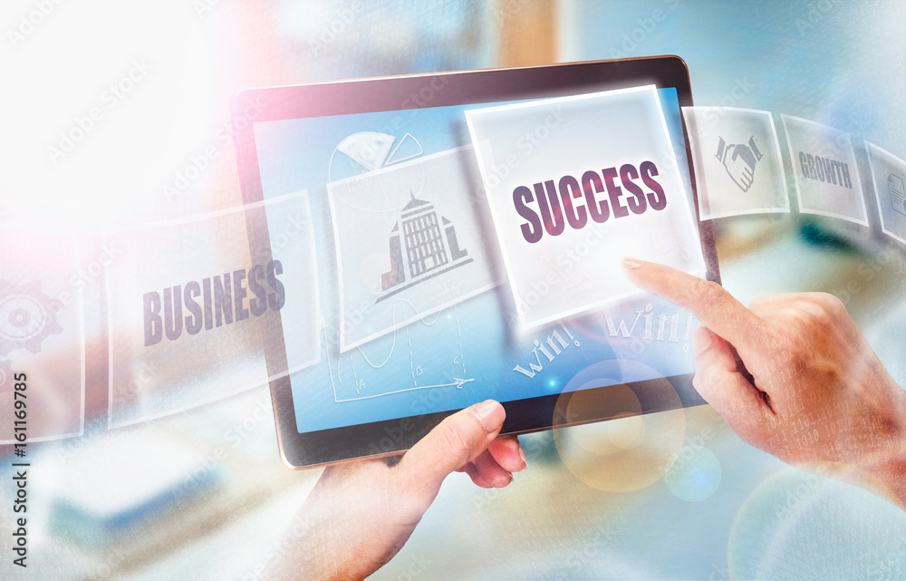 A businesswoman selecting a Success business concept on a futuristic portable computer screen. A businesswoman selecting a Success business concept on a futuristic portable computer screen.