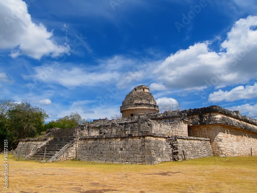 View of the ancient pyramid and the Maya observatory against the background of clouds photo