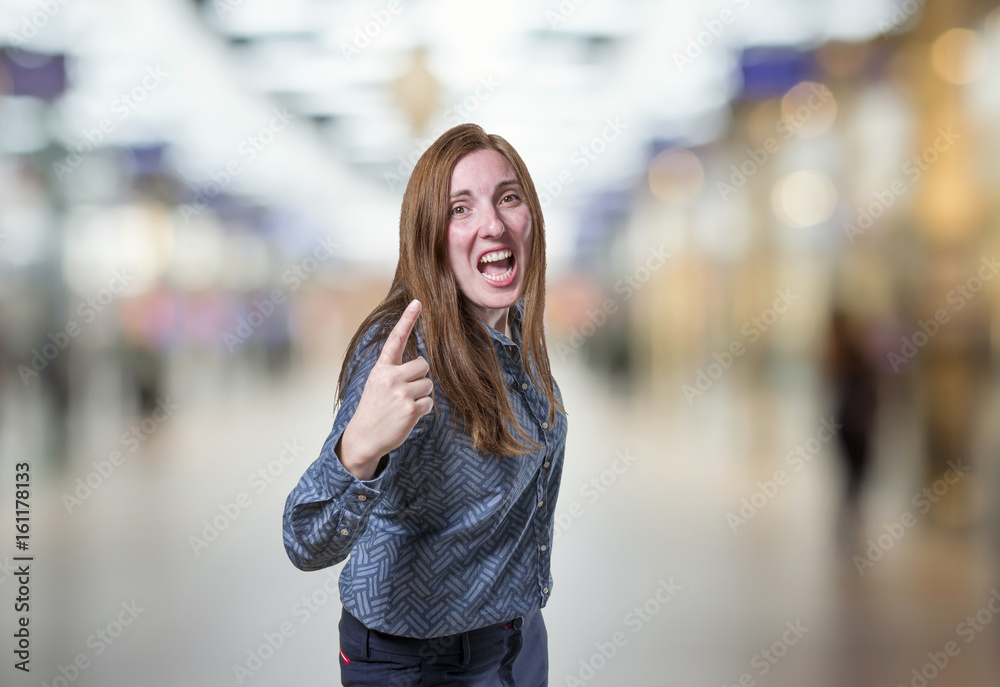 Fototapeta premium Pretty business woman angry over blur background