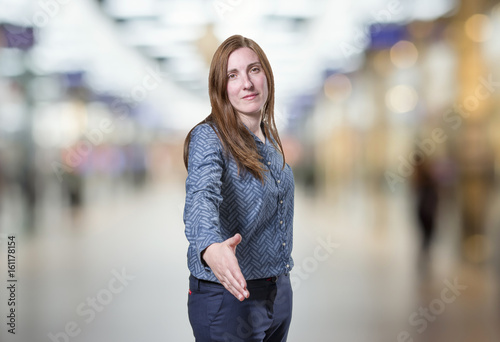 Pretty business woman making a deal over blur background