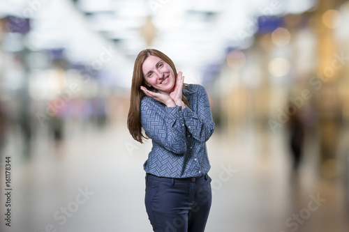 Pretty young businesswoman is happy over blur background