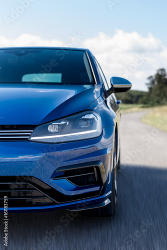 Blue car detail in road with speed blur © Luis Viegas