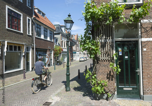 man rides bicycle in sunny street in the centre of leeuwarden in the netherlands photo