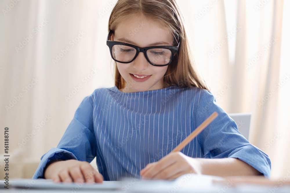Persistent hardworking girl writing something down Persistent hardworking girl writing something down