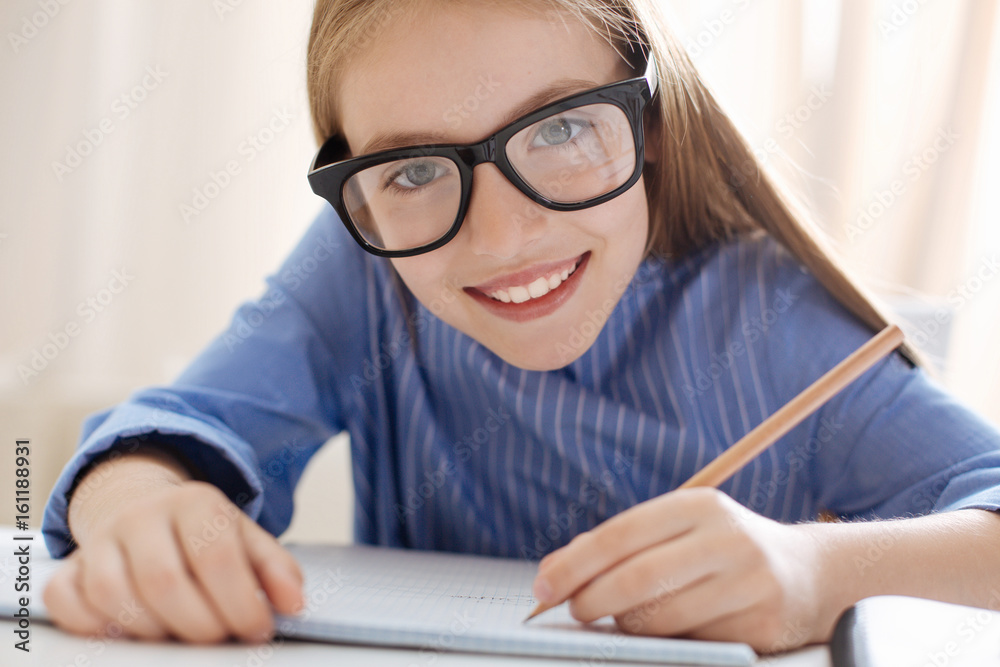 Stunning optimistic girl wearing glasses while studying Stunning optimistic girl wearing glasses while studying