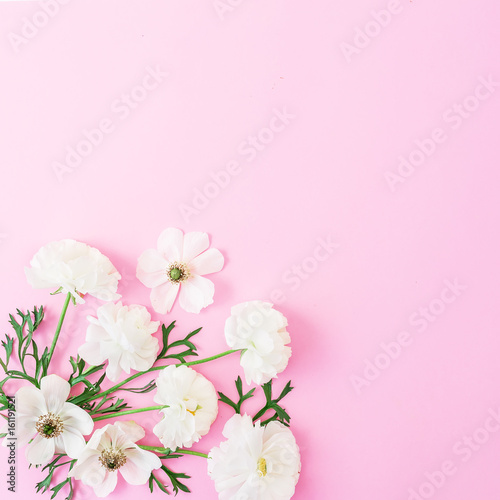 White flowers and leaves on pink background. Floral pattern. Flat lay, top view.