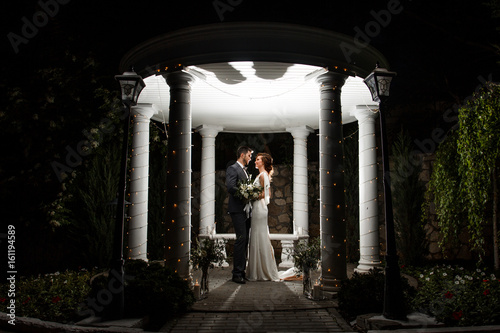 Night wedding ceremony in a beautiful arch and lights photo