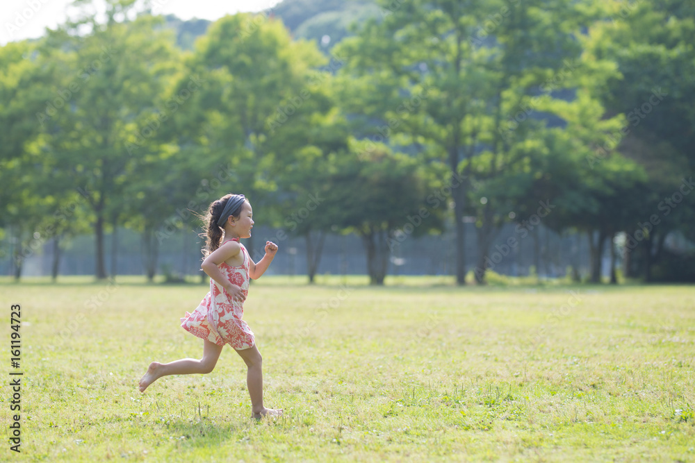 Happy Little Girl running in the meadow
