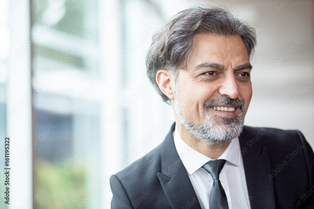 Cheerful modern businessman looking away Cheerful modern businessman looking away