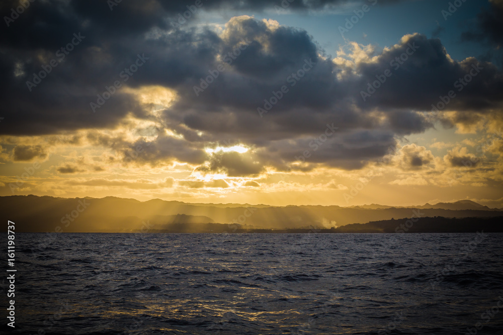 Sun Set over island mountains from the ocean