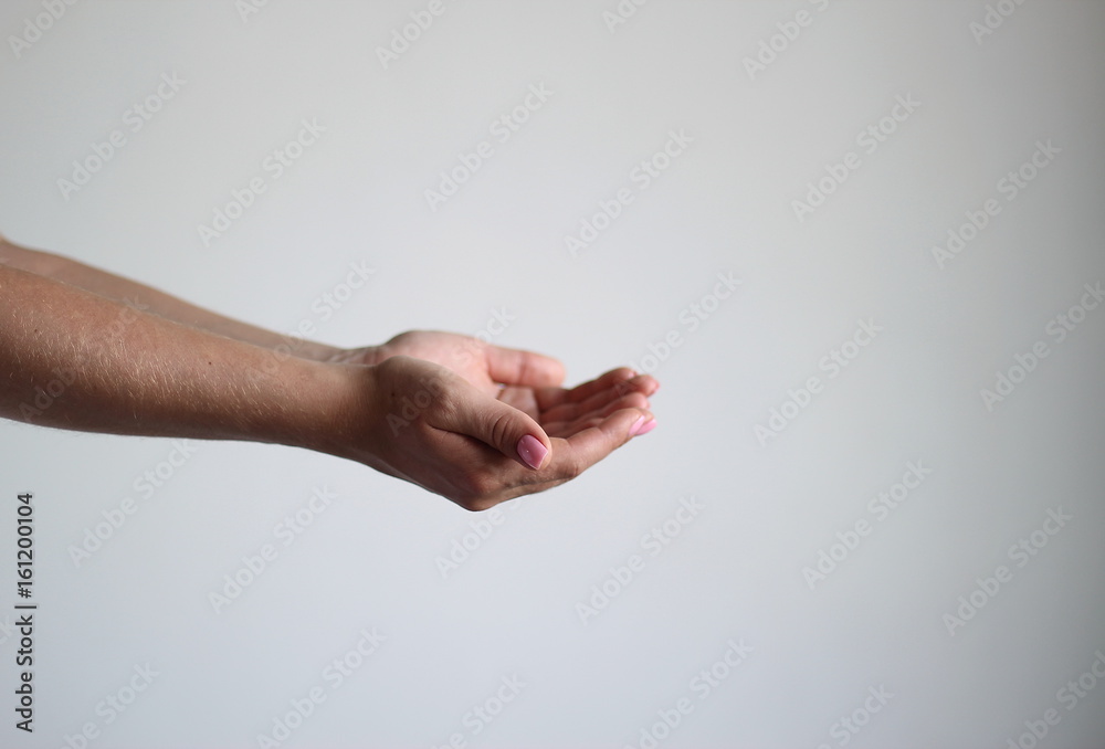 Young woman's hands isolated on light gray background keeps something Gesture Young woman's hands isolated on light gray background keeps something Gesture