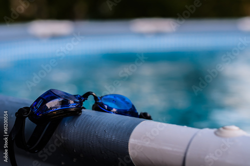 Swimming sport goggles on the poolside