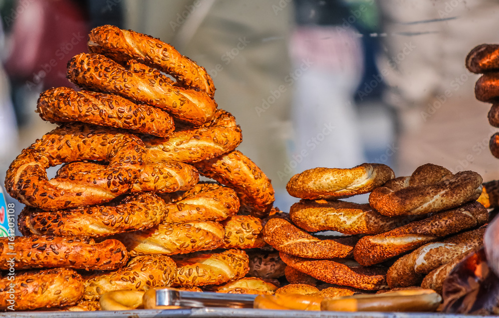 Turkish traditional bagel bread called Simit and other pastries in bench, close up shot