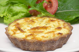 Mini wholemeal quiche with salad in the background