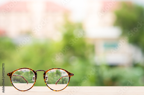 Eyeglasses on wooden table.