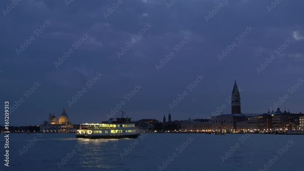 City of Venice, Italy at dusk right after sunset looking west. Focus pull. You can see St. Mark’s Campanile (Campanile di San Marco) to the right and Basilica di Santa Maria della Salute to the left. City of Venice, Italy at dusk right after sunset looking west. Focus pull. You can see St. Mark’s Campanile (Campanile di San Marco) to the right and Basilica di Santa Maria della Salute to the left.