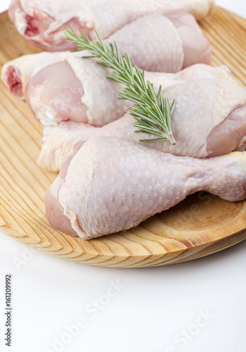 Close-up of uncooked chicken thighs. Vertical studio shot.