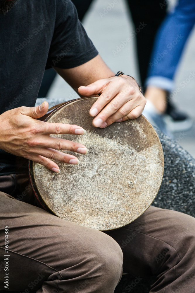Percussionist street artist plays traditional mongolian drum Percussionist street artist plays traditional mongolian drum