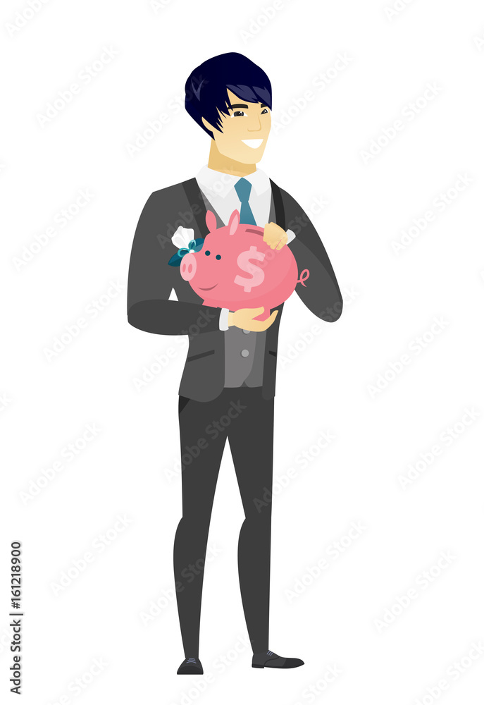 Asian groom holding a piggy bank. Asian groom holding a piggy bank.