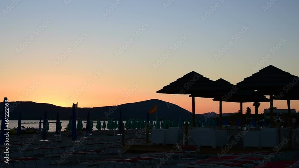 Parasol silhouettes on the beach at sunset Parasol silhouettes on the beach at sunset