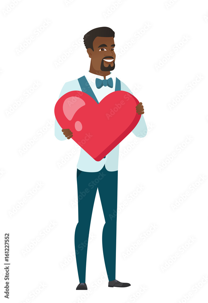 African-american groom holding a big red heart. African-american groom holding a big red heart.