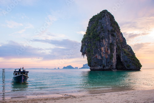 Pinky sky with boat at Railay beach in Krabi Thailand