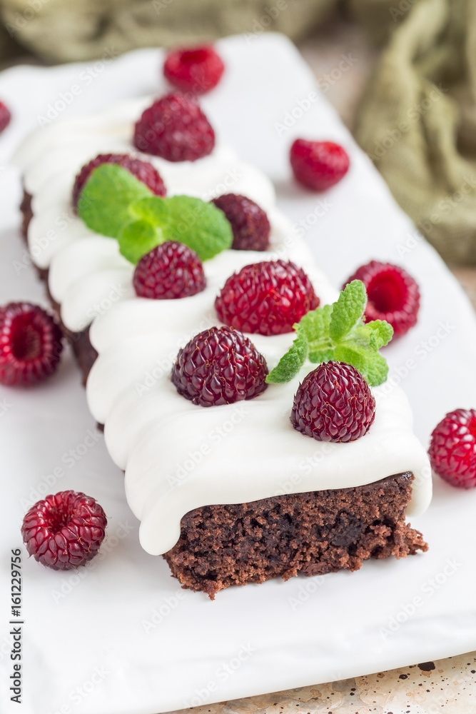 Homemade brownies with cream cheese frosting and raspberry Homemade brownies with cream cheese frosting and raspberry