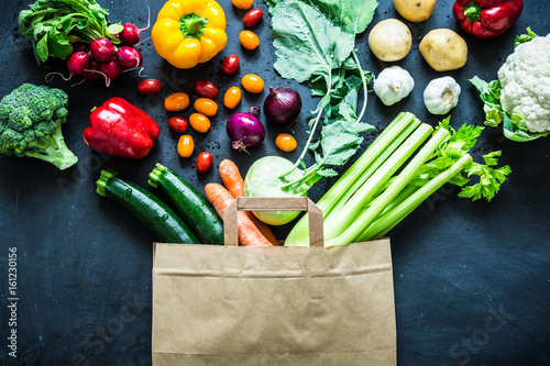 Colorful organic vegetables in paper eco shopping bag