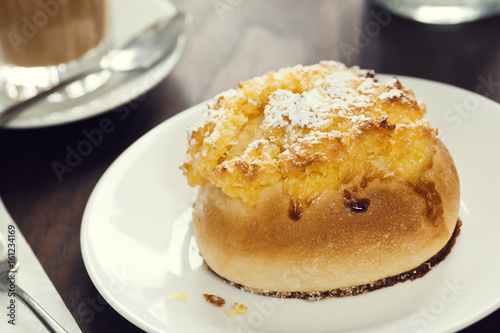 Pão de Deus, a Portuguese Sweet Roll with Coconut and Powdered Sugar Topping in Cafe