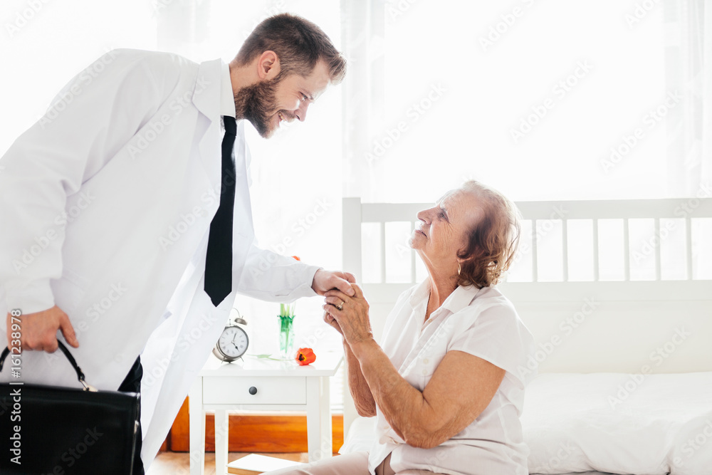 Providing care for elderly. Doctor visiting elderly patient at home. Providing care for elderly. Doctor visiting elderly patient at home.